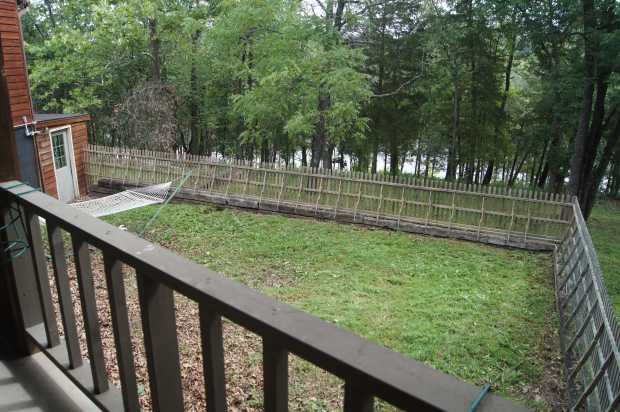 Fenced yard seen from carport at Caro Drive